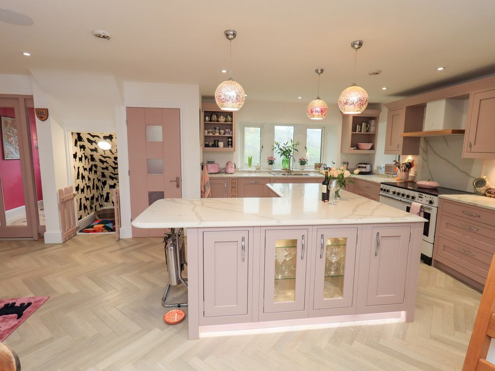 A kitchen with an island and oven at Hallbeck in Buckden