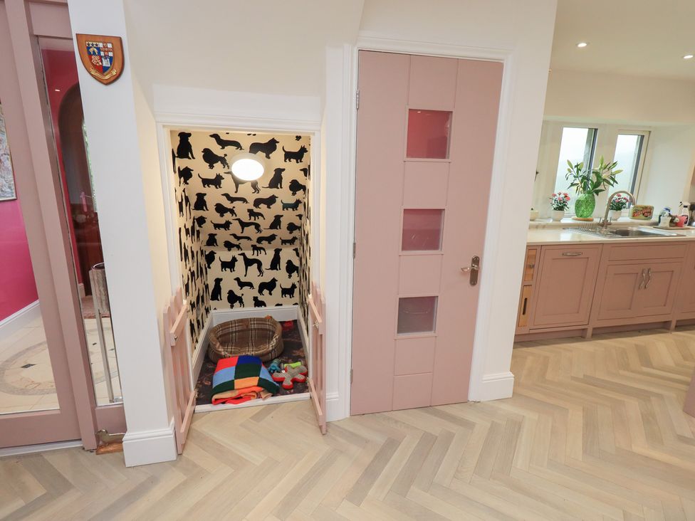 A hallway with a door and a dog bed in a space at Hallbeck in Buckden