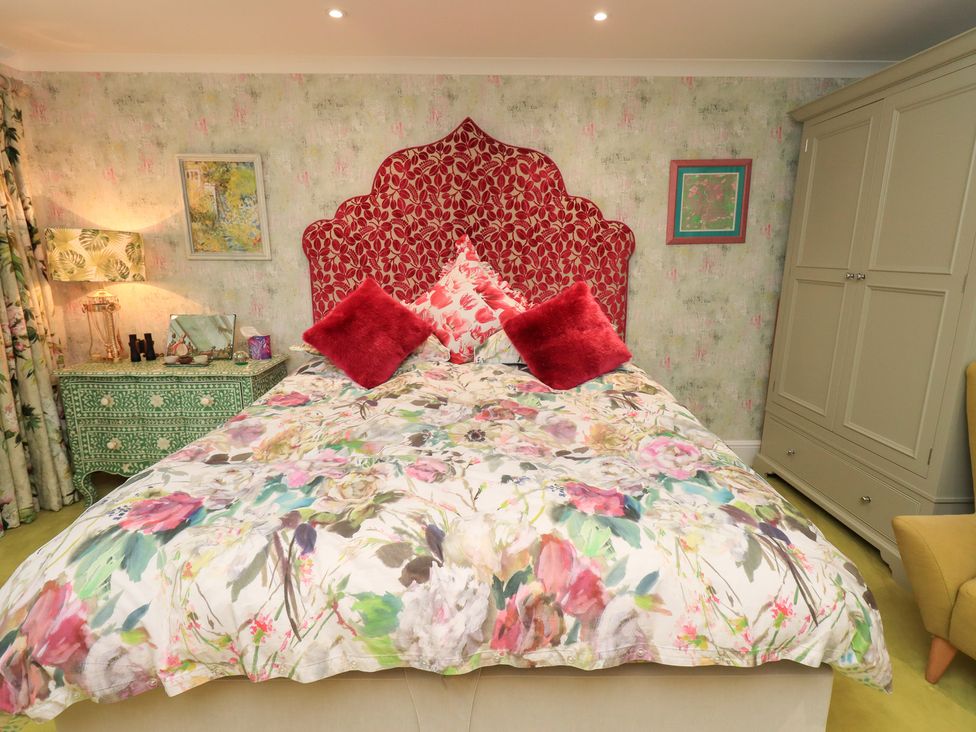 A bedroom with a bed and bedside table at Hallbeck in Buckden