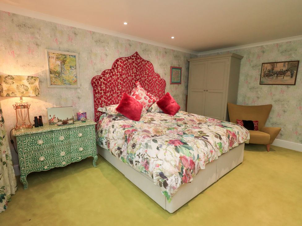 A bedroom with a bed and bedside table at Hallbeck in Buckden