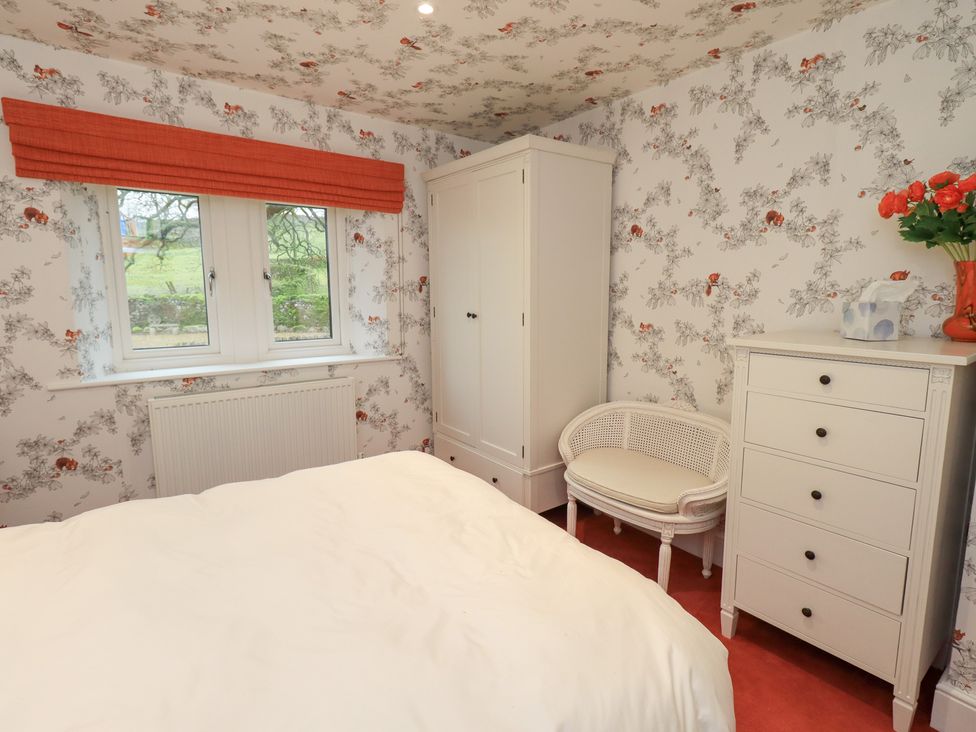 A bedroom with a bed and wardrobe at Hallbeck in Buckden
