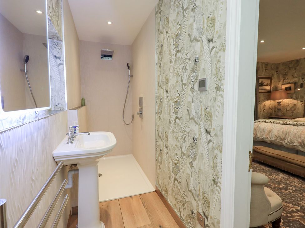 A bathroom with a sink and shower at Hallbeck in Buckden