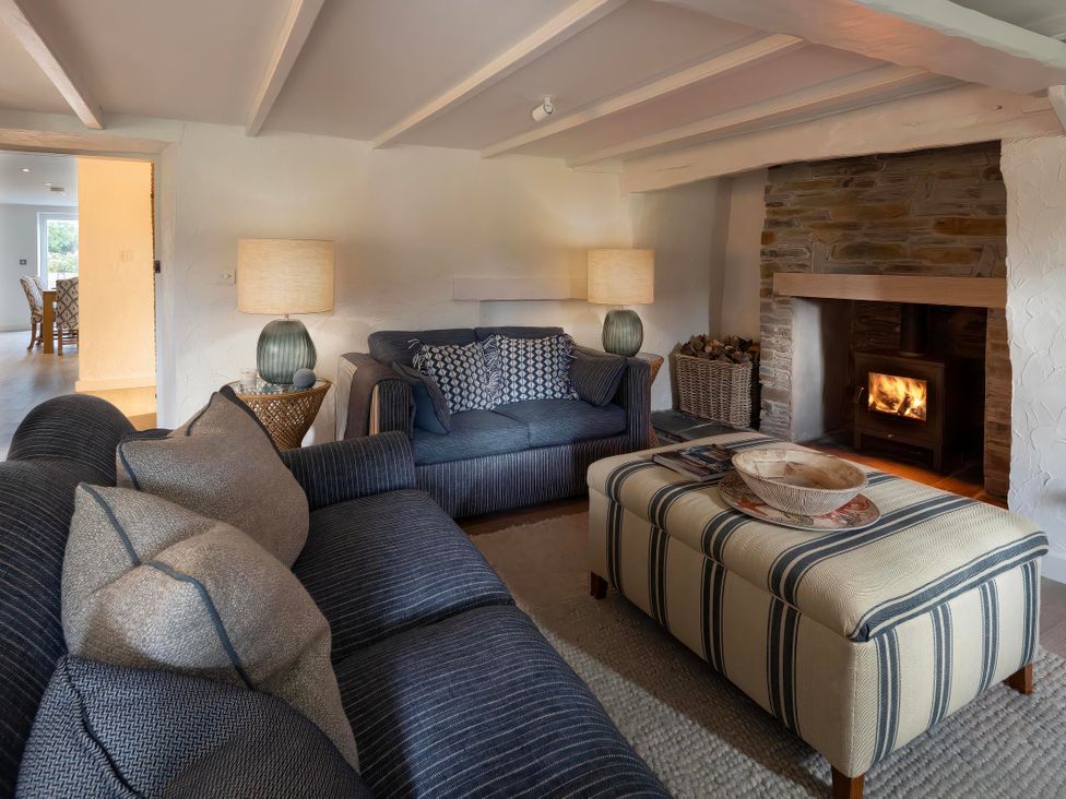 A living room with a sofa and fireplace at Rose Cottage in Wadebridge