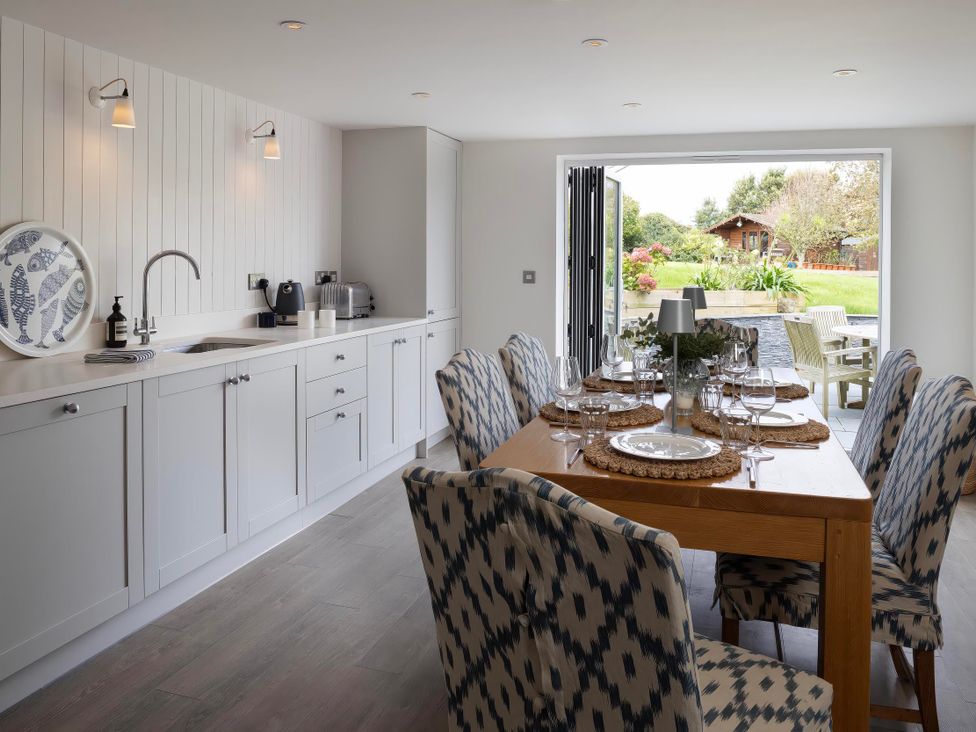 A dining room with a table set for dinner at Rose Cottage in Wadebridge