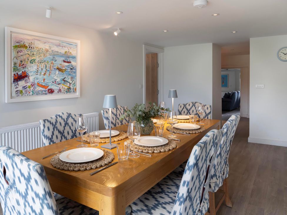 A dining room with a table set for dinner at Rose Cottage in Wadebridge