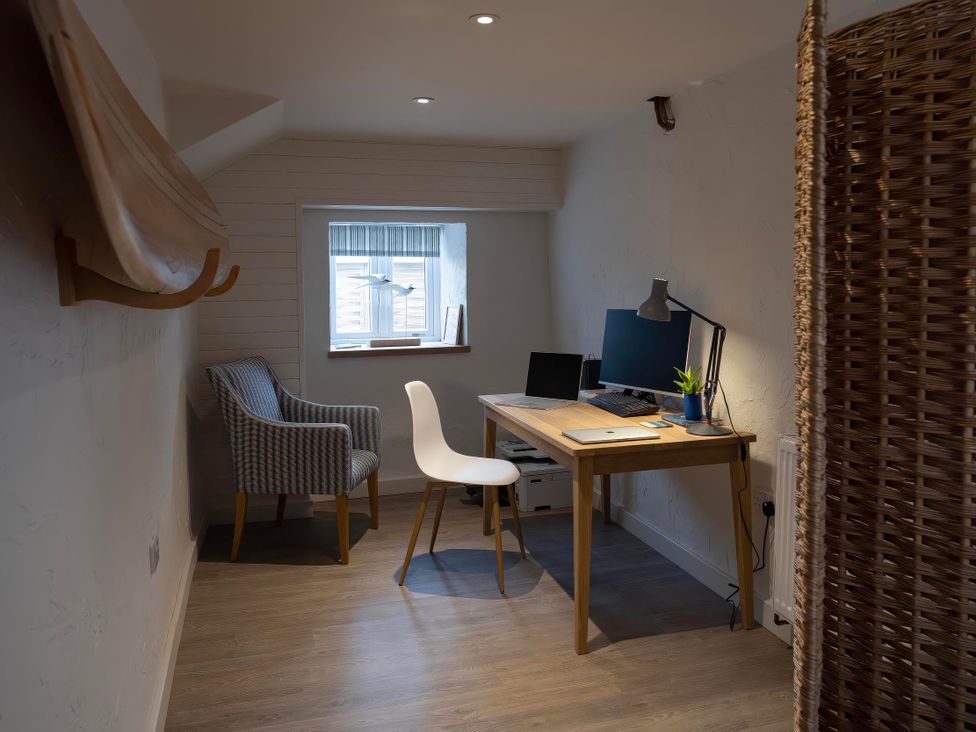 An office with a desk and computer at Rose Cottage in Wadebridge