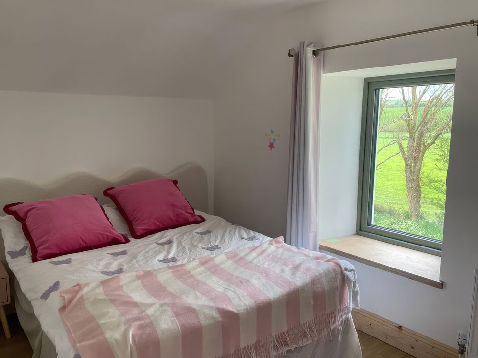 A bedroom with a bed and window at Knocknanuss