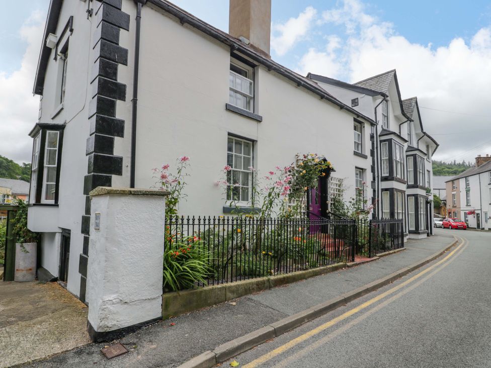 A house with flowers in the garden on a street at Bryn Dwr in Llangollen