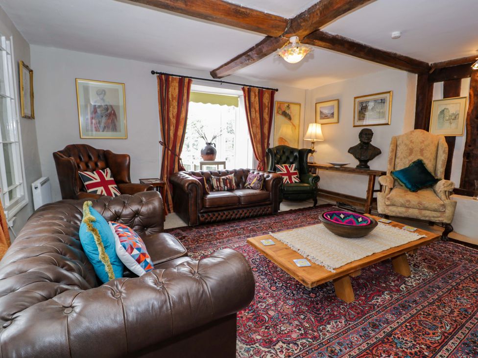 A living room with a sofa and armchairs at Bryn Dwr in Llangollen