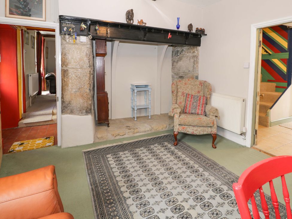 A living room with an armchair and small table at Bryn Dwr in Llangollen