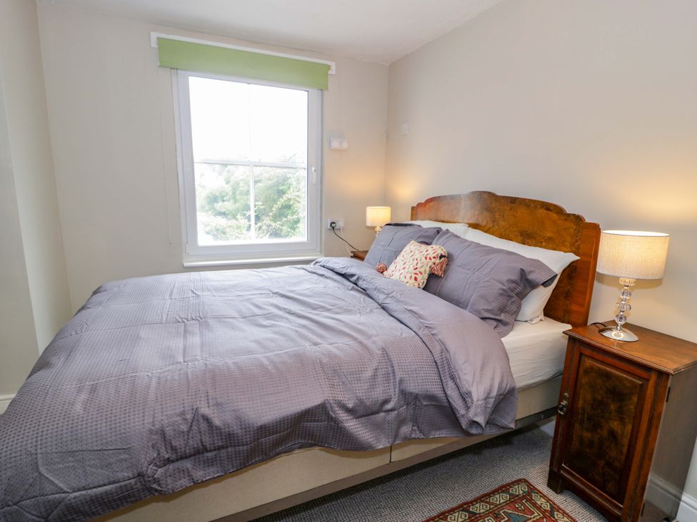 A bedroom with a bed and a window at Bryn Dwr in Llangollen