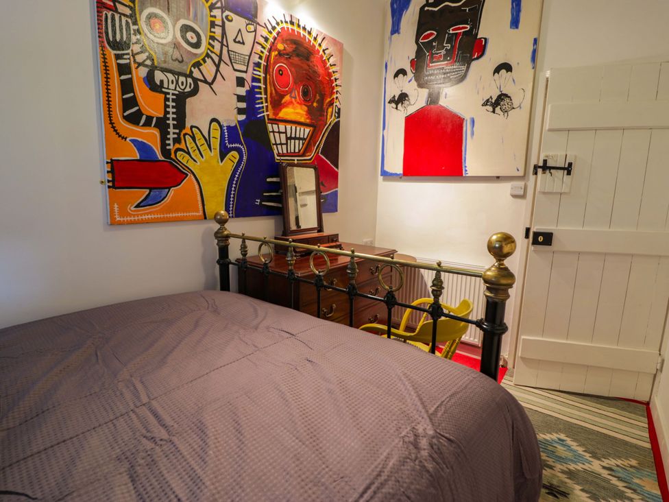 A bedroom with a bed and artwork at Bryn Dwr in Llangollen