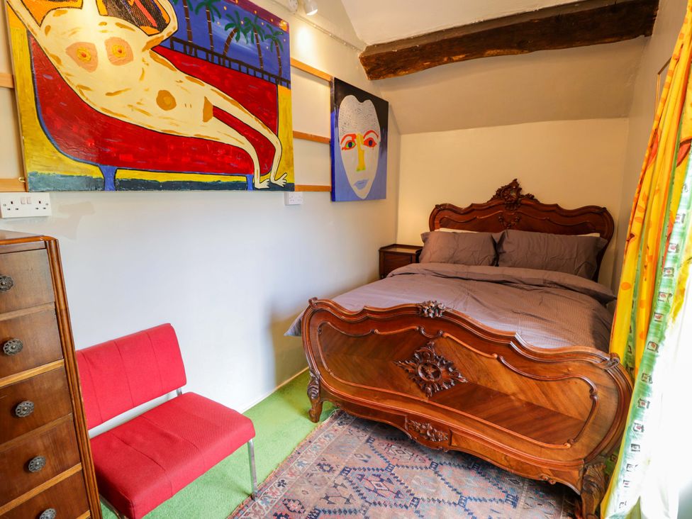 A bedroom featuring a bed and artwork at Bryn Dwr Llangollen