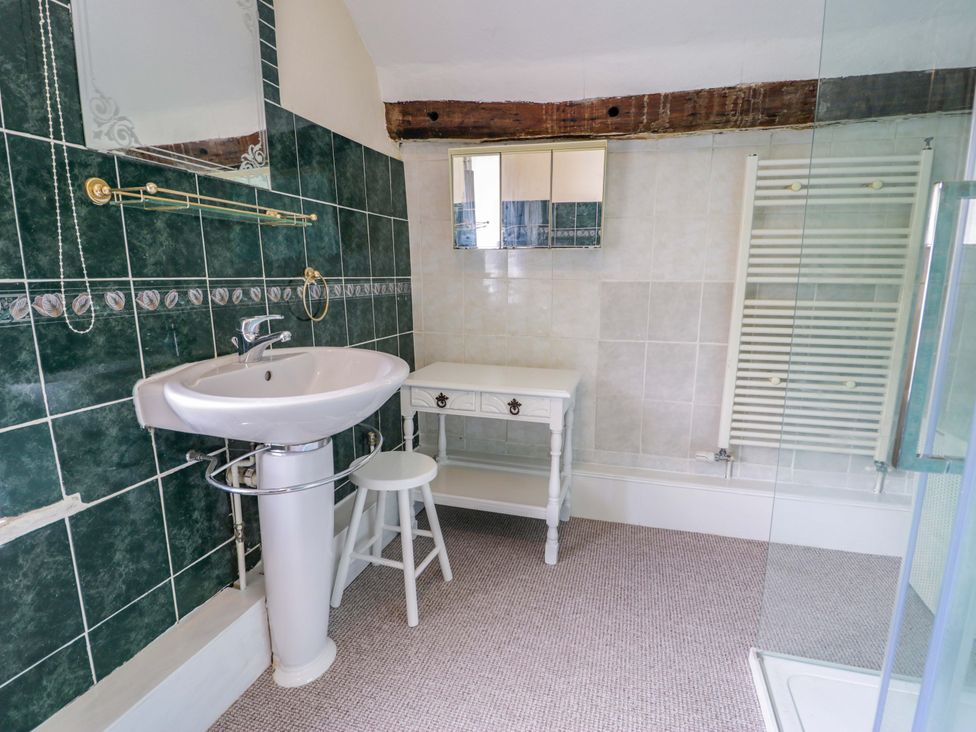 A bathroom with sink and stool at Bryn Dwr in Llangollen