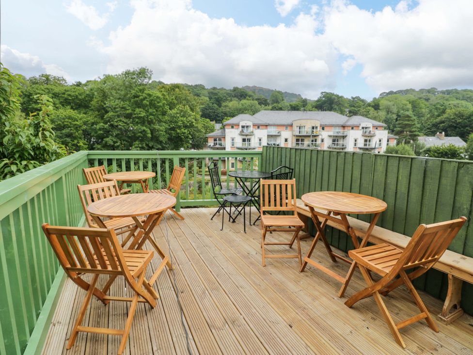 An outdoor area with wooden furniture at Bryn Dwr in Llangollen