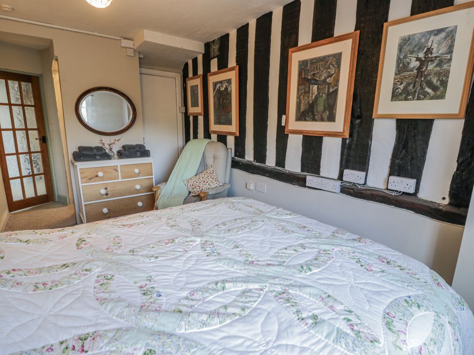A bedroom with a bed and a dresser at Bryn Dwr in Llangollen