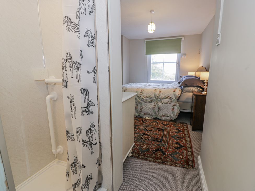 A bedroom with a bed and a shower area at Bryn Dwr in Llangollen