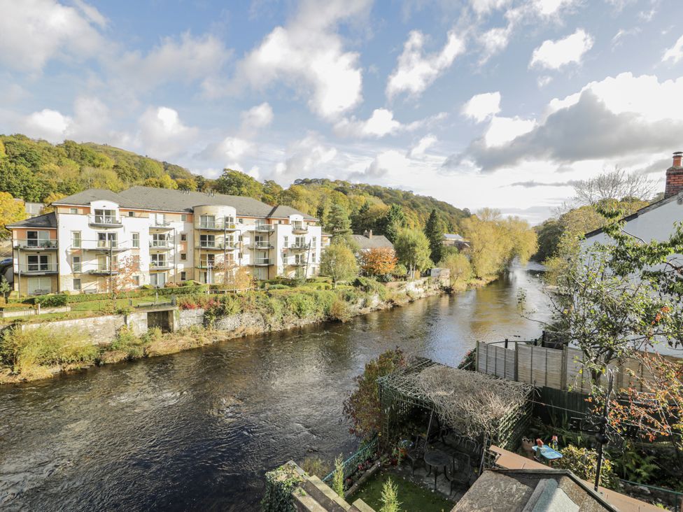 A view of an apartment building by a river at Bryn Dwr in Llangollen
