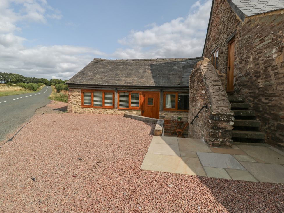 An outdoor view of a house with gravel path at The Old Cart Shed in Gorsley