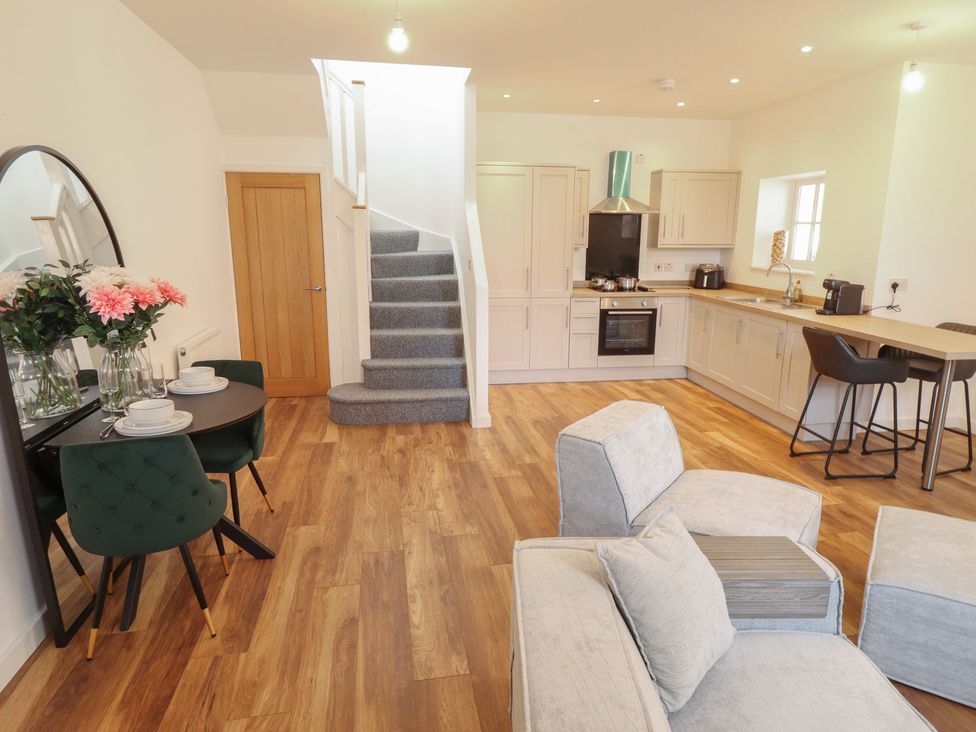 A living room with a sofa and dining area at 10c King Street in King's Lynn