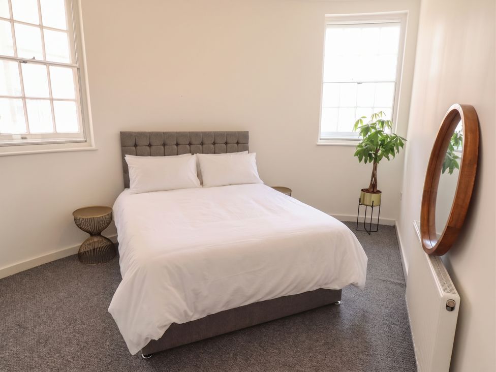 A bedroom with a bed and bedside tables at 10c King Street in King's Lynn