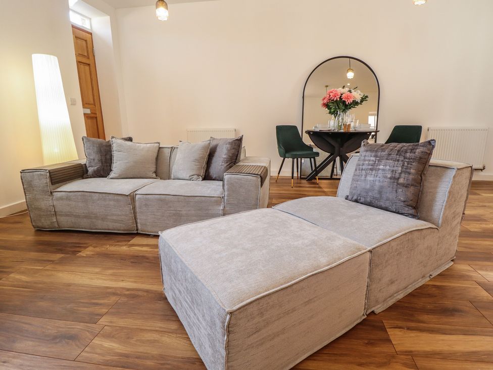 A living room with a sofa and table at Corner House in King's Lynn