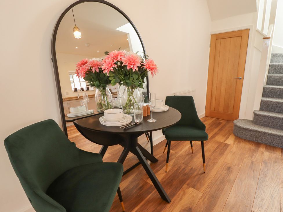 A dining room with a table and chairs at Corner House in King's Lynn