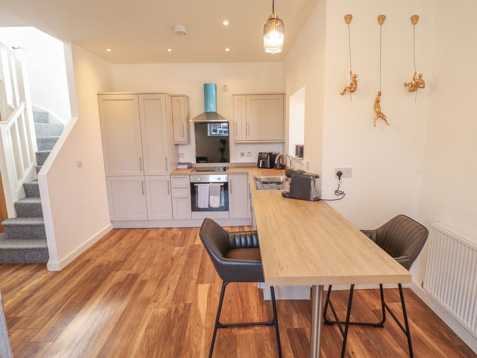 A kitchen with cabinets and appliances at Corner House in King's Lynn