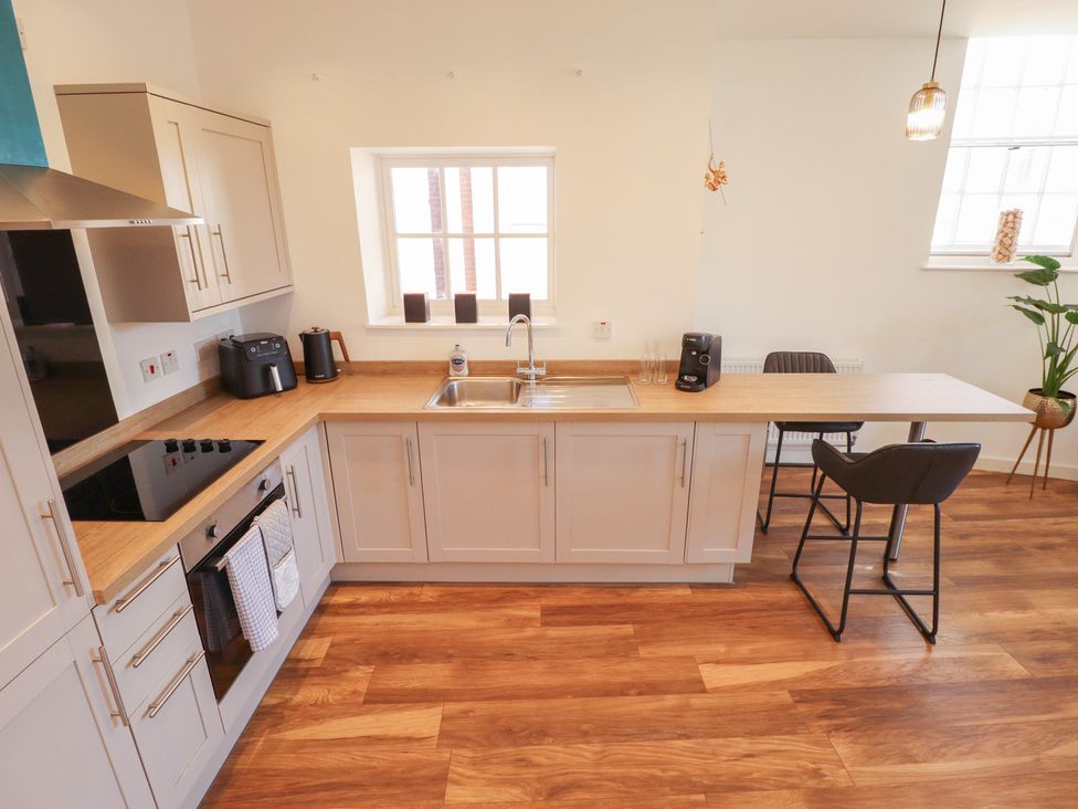 A kitchen with a sink and appliances at Corner House in King's Lynn