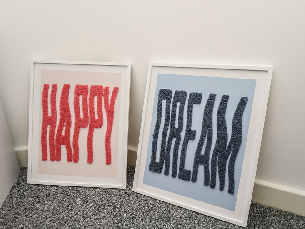 Framed art with text 'HAPPY' and 'DREAM' at Corner House in King's Lynn