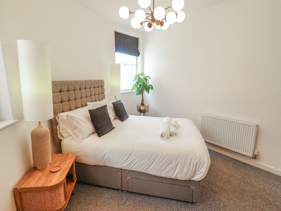 A bedroom with a bed and lamp at Corner House in King's Lynn