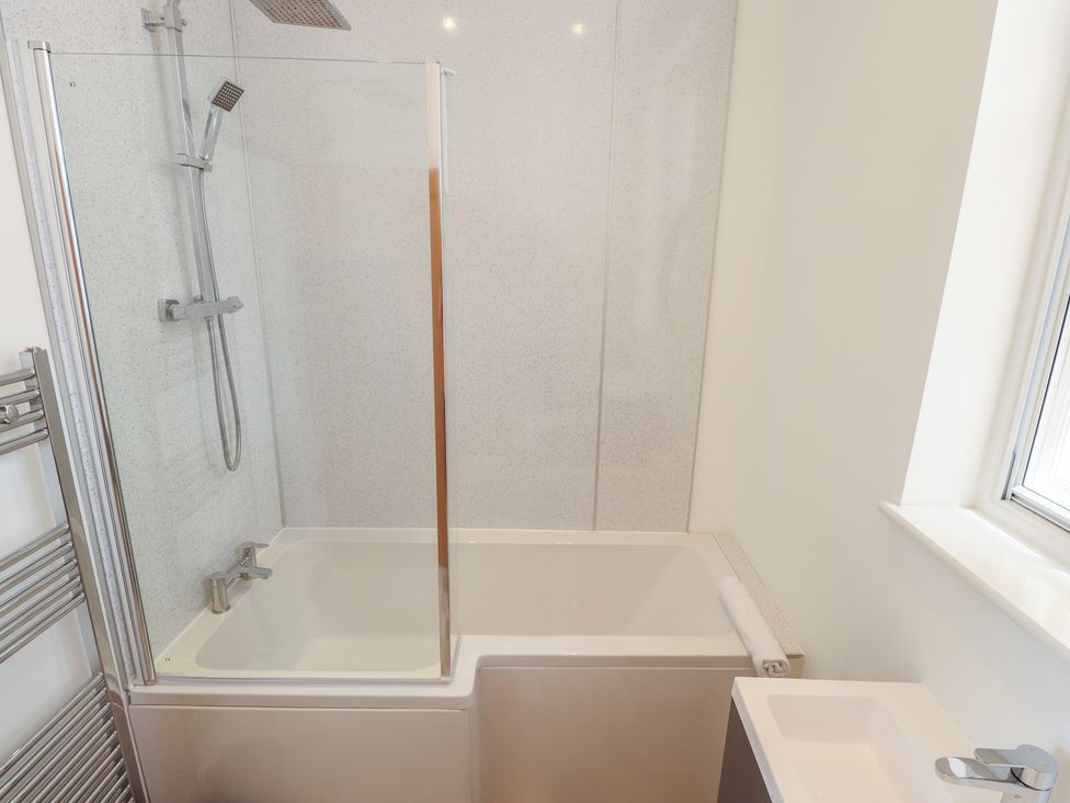 A bathroom featuring a bathtub and shower at Corner House in King's Lynn
