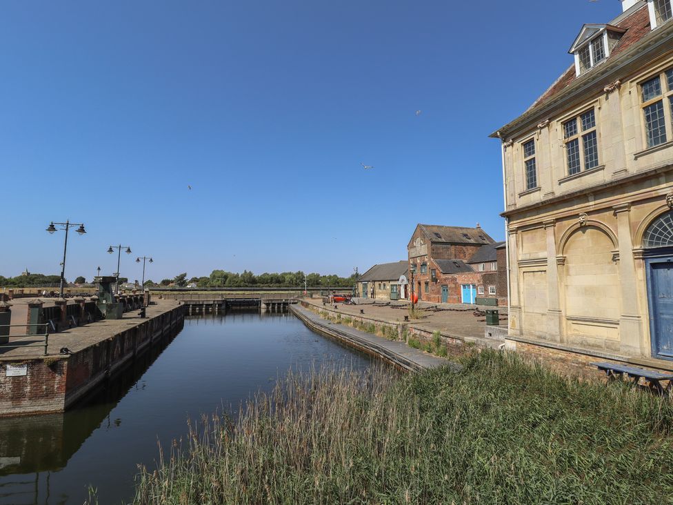 A waterfront scene with buildings and a canal at Corner House in King's Lynn