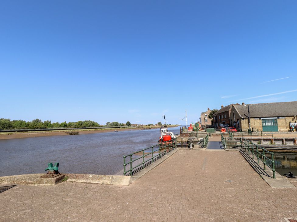 A river with docks and buildings at Corner House in King's Lynn
