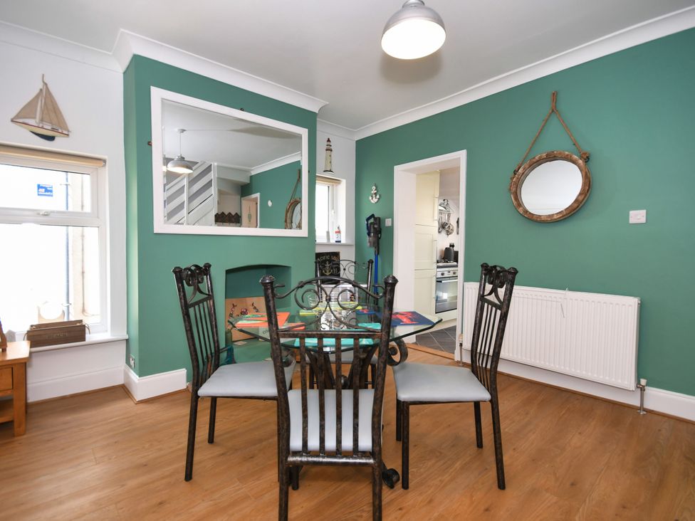 A dining room with table and chairs at Seahorse in Filey