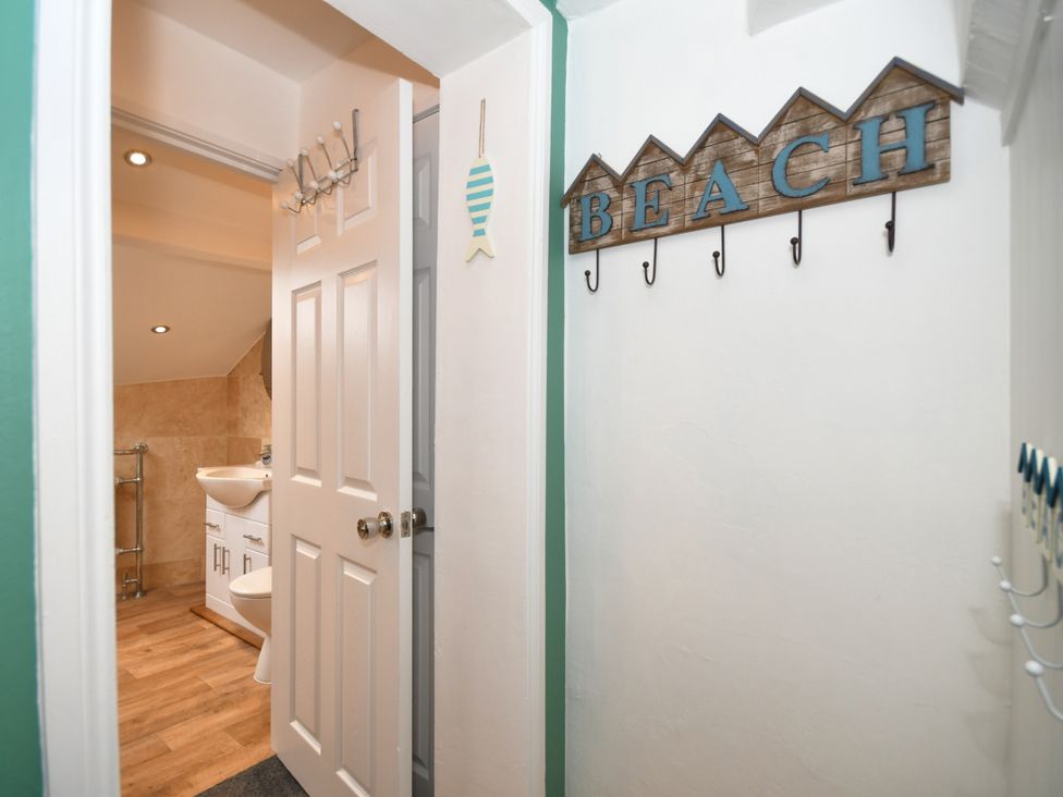 A bathroom with a sink and door at Seahorse in Filey