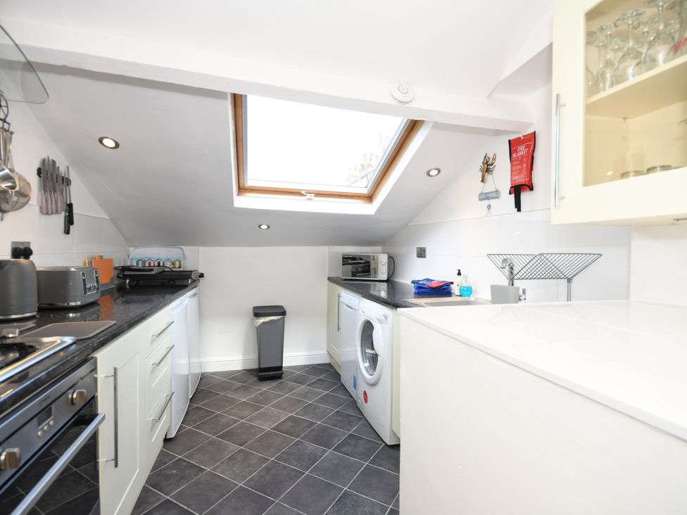 A kitchen with appliances and a skylight at Seahorse in Filey