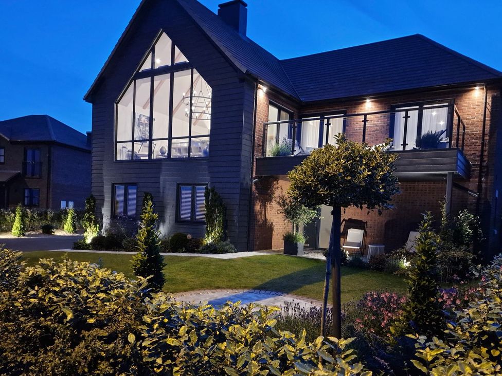 A house with a balcony and garden at Calm Waters Luxury Beach House in Bridlington