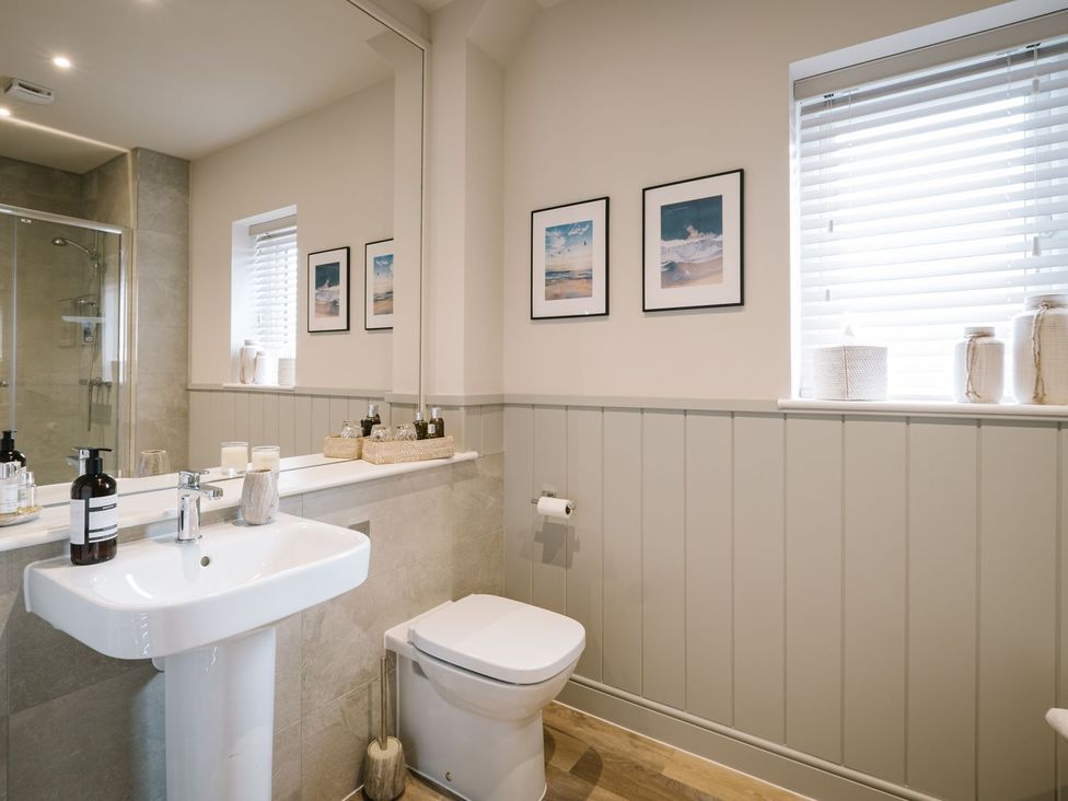A bathroom with a sink and toilet at Calm Waters Luxury Beach House in Bridlington