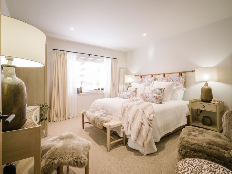 A bedroom with two beds and a window at Calm Waters Luxury Beach House in Bridlington