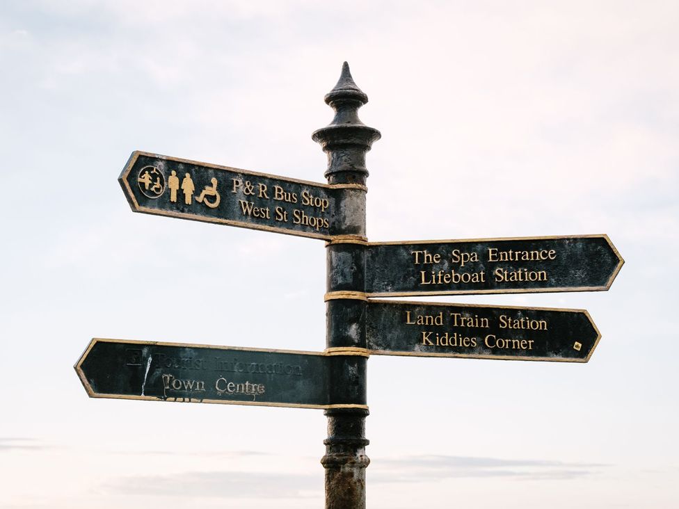 A directional sign with multiple location options at Calm Waters Luxury Beach House in Bridlington
