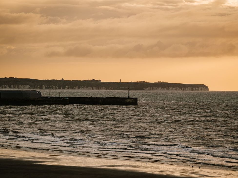 A view of the ocean and cliffs at Calm Waters Luxury Beach House in Bridlington
