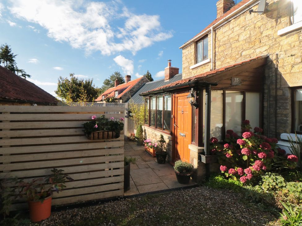 An outdoor area with a house and pathway at 35 High Street in Scarborough