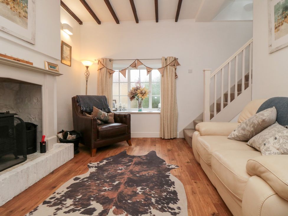 A living room with an armchair and a sofa at Minn's Cottage in Snainton