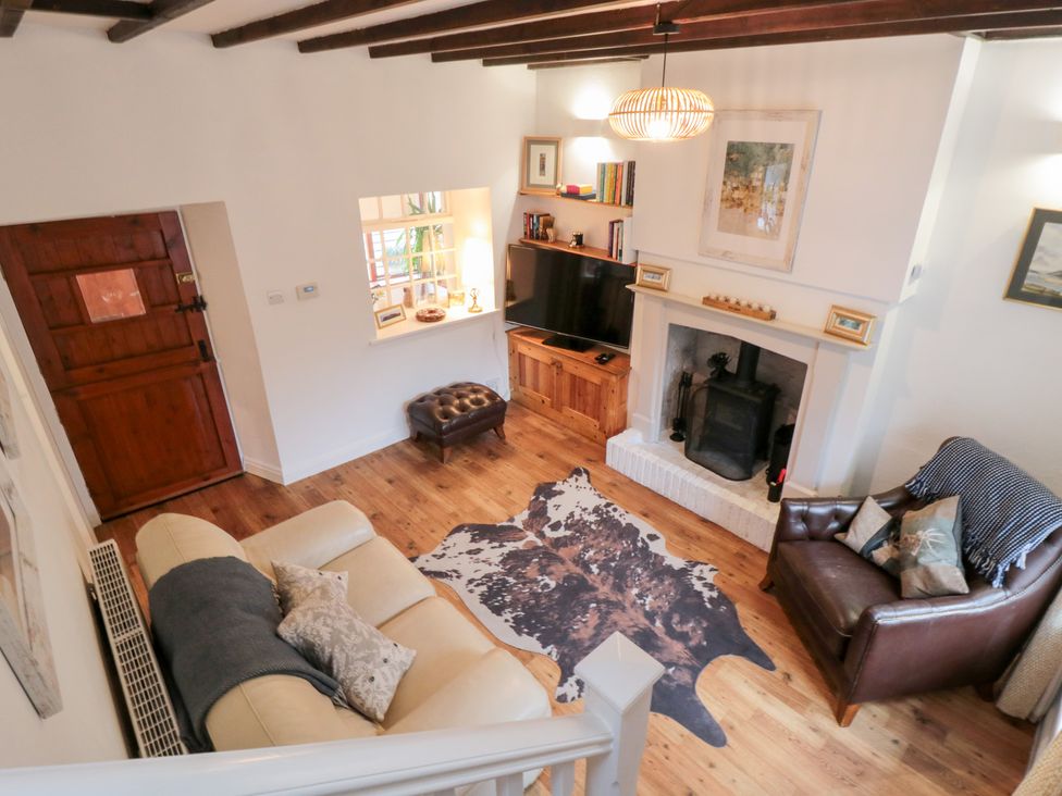 A living room with a sofa and armchair at Minn's Cottage Snainton
