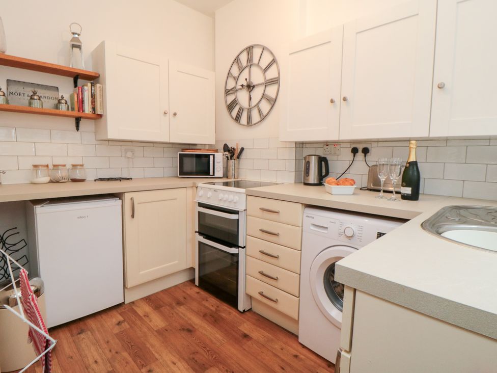 A kitchen with appliances and storage at Minn's Cottage Snainton
