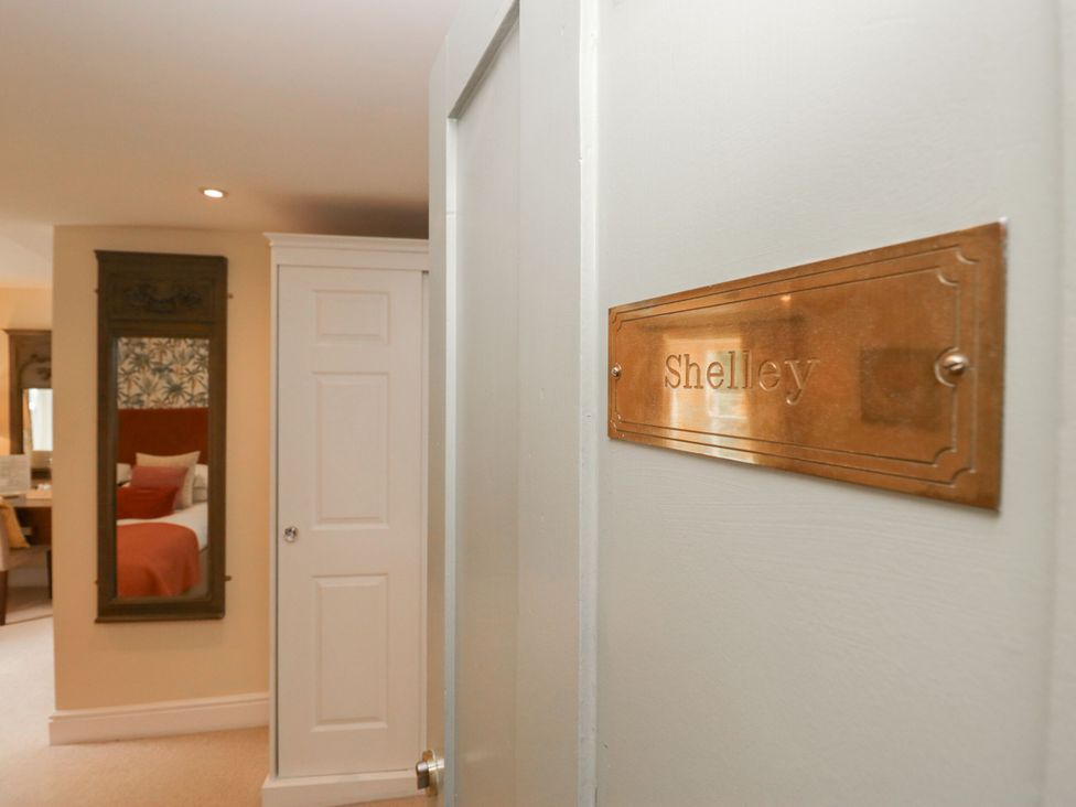 A bedroom with a door and nameplate at Shelley in Ambleside