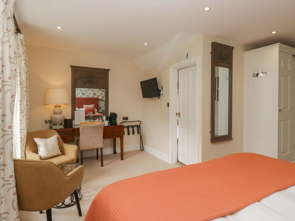 A bedroom with a bed and a desk at Shelley in Ambleside