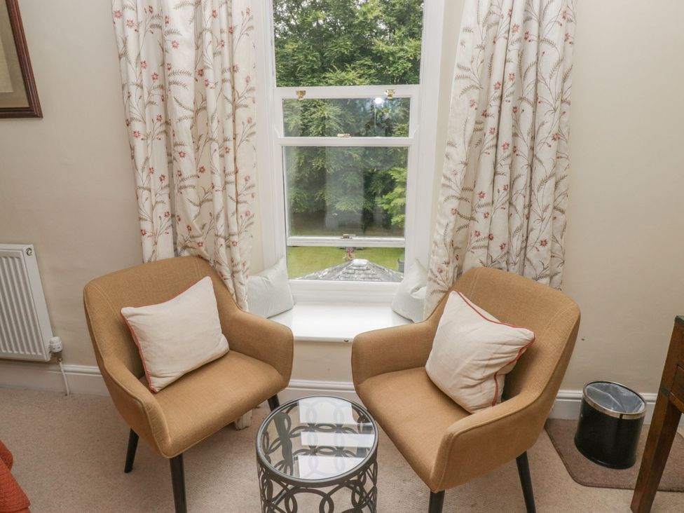 A snug with two armchairs and a side table at Shelley in Ambleside