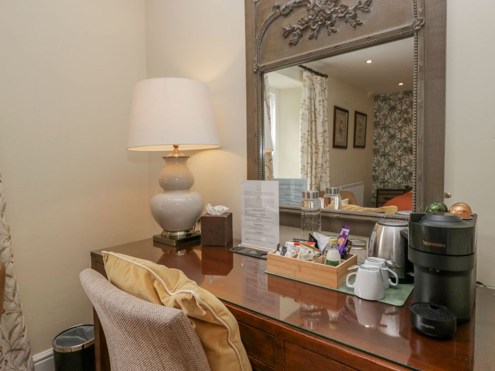 A desk with a lamp and Nespresso machine at Shelley in Ambleside